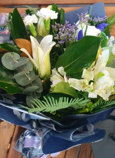 Ava - A creamy selection of blossoming buds in shades of white, complimented by greenery and carefully hand-tied. Beautifully presented, only the perkiest petals make up this creation. Include a message for that personal touch.
