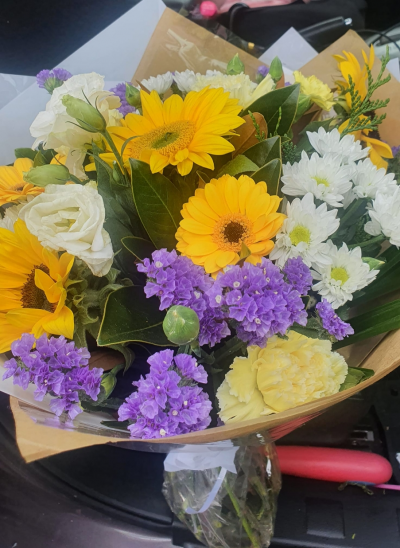 Sunshine Bouquet - A pleasing colour selection suitable for any occasion. The florist will select yellows, whites and greens to deliver a lovely hand tie bouquet.