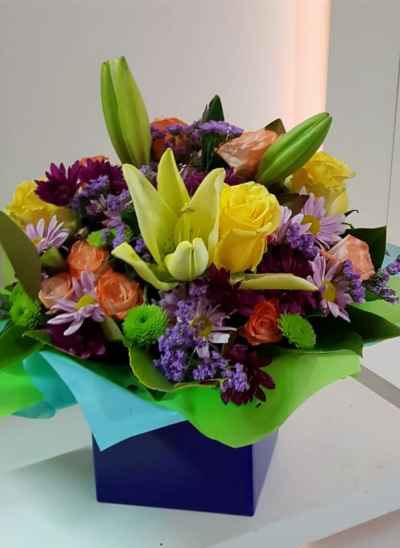 Sunrise - Energise their day with a stunning surprise. A warm collection of seasonal flowers artistically arranged by an artistic florist.